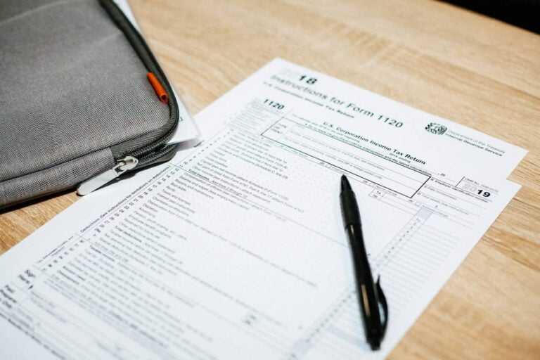 A document and a pen on a wood table